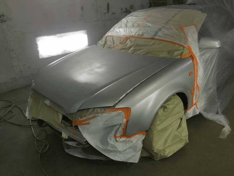 Sedan masked off and freshly painted in our booth